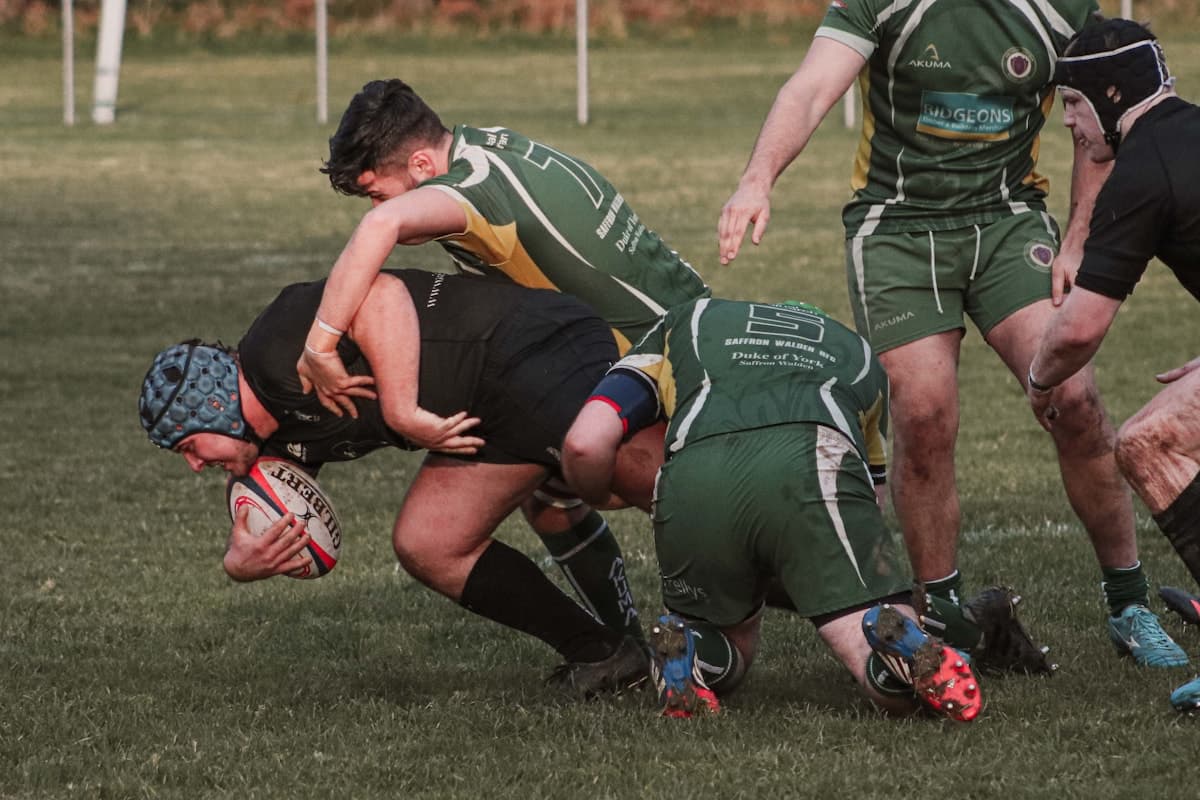 Rugby union players in a competitive match on a grass field